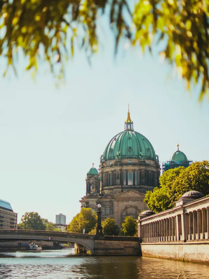 Berlin Cathedral on the Spree, framed by leaves